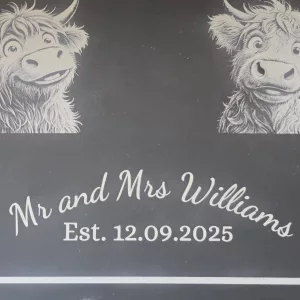 mr and mrs highland cow cheese slate close up