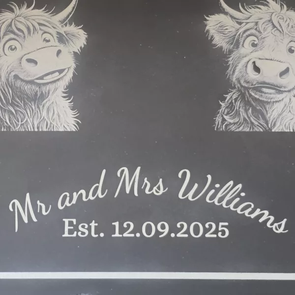 mr and mrs highland cow cheese slate close up